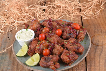 fried chicken with tomatoes and caramelized onions wings with herb sauce