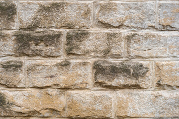 Rough textured wall surface made of huge blocks of natural stone. Background or backdrop. Design blank