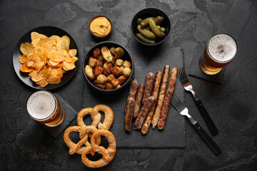 Glasses of cold beer and different snacks on black background. Oktoberfest celebration