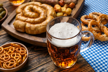 Mug of cold beer on wooden background. Oktoberfest celebration