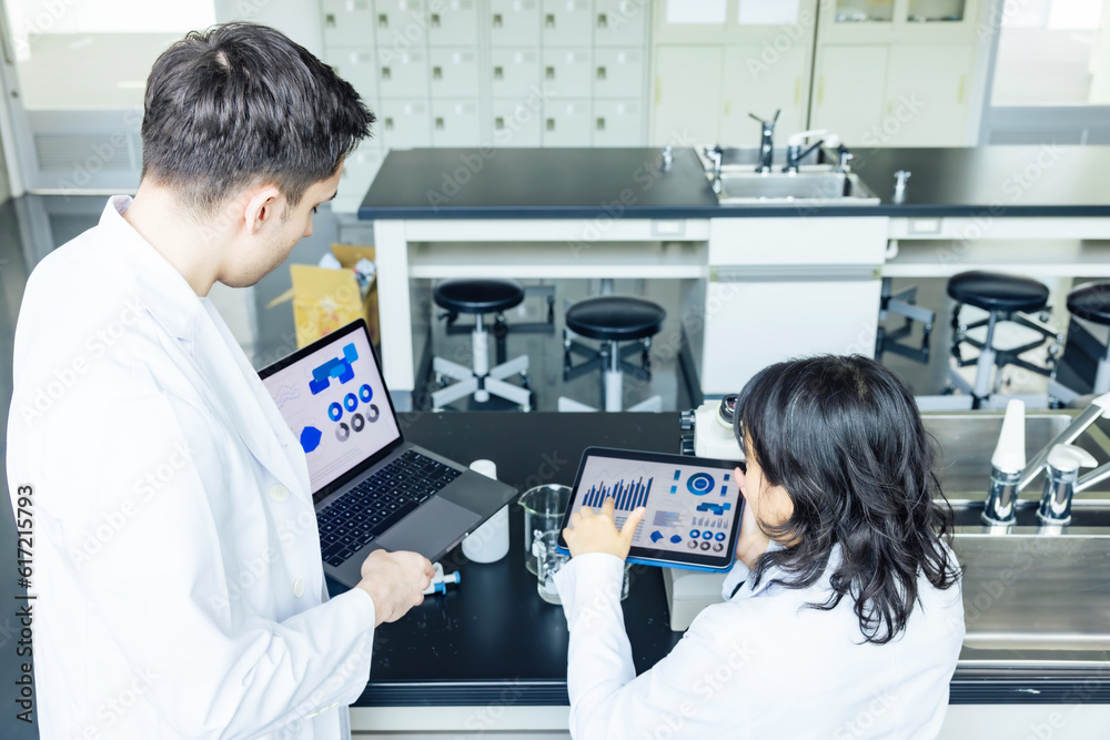 Aufkleber group of researchers looking at tablet data in the lab. research and development.