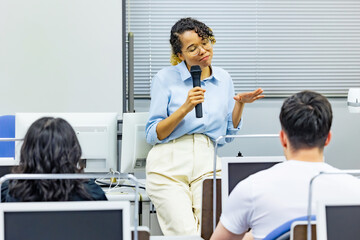 Female teacher teaching in class room. Business seminar.
