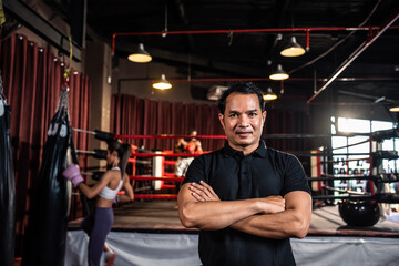 Portrait of Asian male referee enforces the rules of the boxing match.  - obrazy, fototapety, plakaty