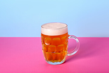 Mug of cold beer on color background