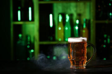 Mug of fresh beer on table in bar