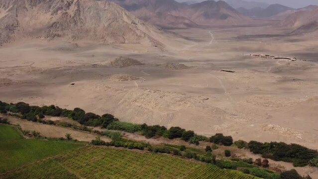 Aerial footage of the ancient pyramid city of Caral. The oldest in the Americas. Drone orbits above the archaeological site. Located in the Supe Valley in Lima, Peru.