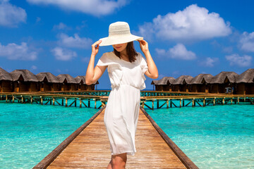 Woman standing on the wooden pier