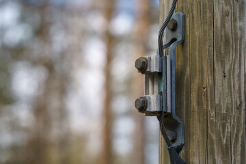 Wire connector for ground wire on a wooden electric pole outdoors
