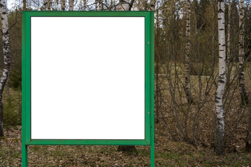 Empty white billboard with green frame and nature background.