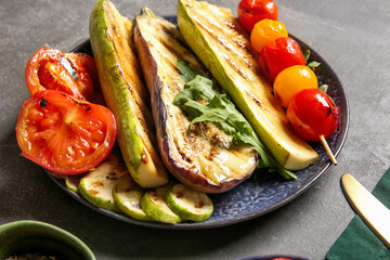 Plate with tasty grilled vegetables on dark background