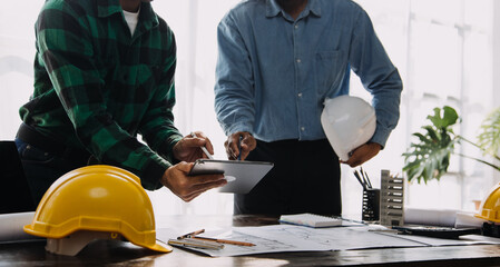 Construction and structure concept of engineer working drawing on blueprint meeting for project working with partner on model building and engineering tools in working site, construction concept.