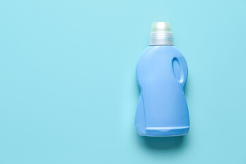 Bottle of detergent on blue background