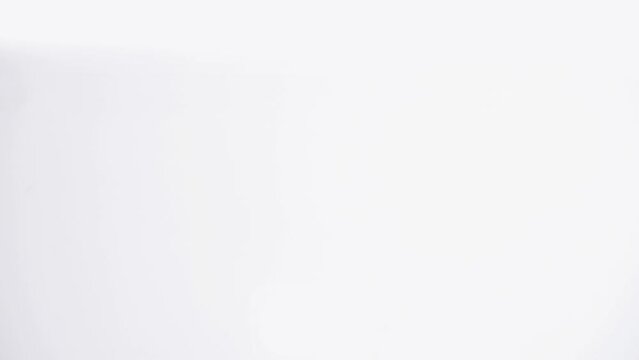 Hand makes gesture of pointing or pressing an object on white stage, man's hand