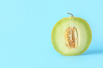 Half of sweet melon on blue background