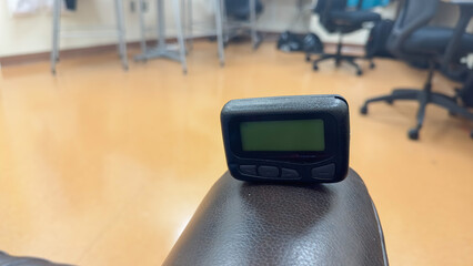 pager beeper device rests on a desk, representing the power of instant communication, connectivity, and the evolution of technology