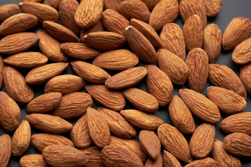 Whole shelled almond nuts kernels studio background