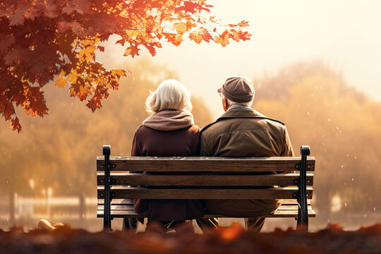 Back view of senior couple sitting on a bench in an autumn park, Generative AI