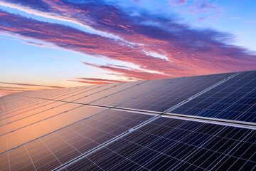 Solar panels and colorful sunset clouds. green energy concept.