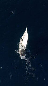 Vertical Video: Cinematic Drone Footage - Sailing Yacht Towards Mediterranean Port