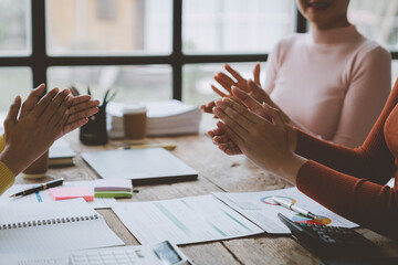 Team of successful business women clapping in modern workstation great work and celebrations in the...