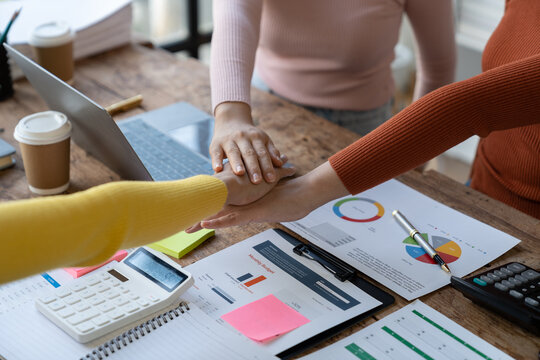Image of business women's hands putting together handshake show partner Power promise trust, work trust, respect, fight, touch stack fist bump to agree to work together. invest. teamwork concept.