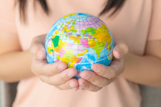 Close Up Woman's Hand Holding A Globe. Earth In Human Hand. World Environment And Earth Day. Save The World Concept. Environment Save, Taking Care Of Nature And Ecology, Globe Worldwide Protection.