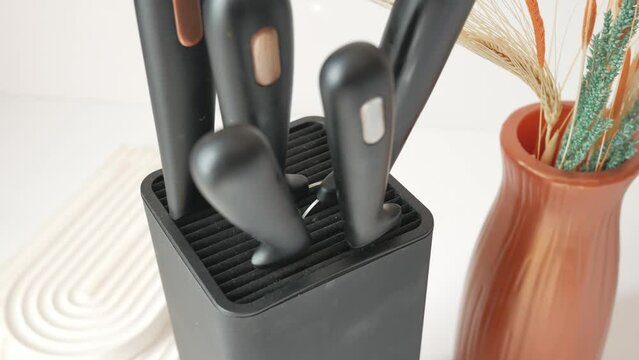 Set of kitchen knives in a box .