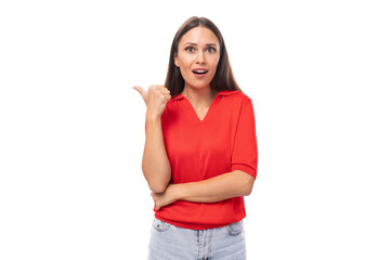 surprised brunette woman in a red stylish v-neck blouse shows her hand to the empty space