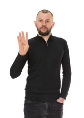 Portrait of serious thirty year old man showing and pointing up with fingers number four isolated on white background. Bearded man in black jeans and turtleneck posing in studio. Number 4.