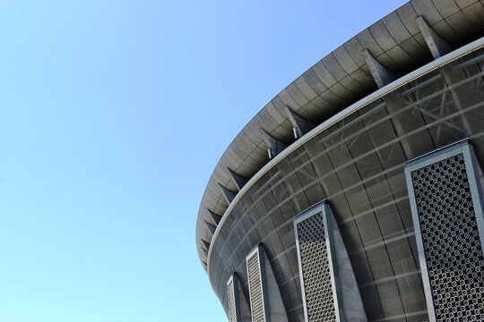 Budapest. 06.23.2023: soccer stadium and sport centrum. concrete cladding. steel frame with metal exterior panels. clear blue summer sky. modern architecture. landmark modern new sport arena