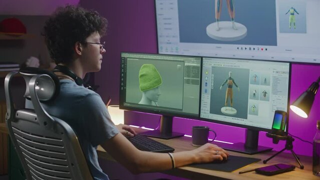 Young 3D designer creates game character or clothes, works on project at home. Teenager trains 3D modeling on computer and big digital screen with professional software interface and tools for design.