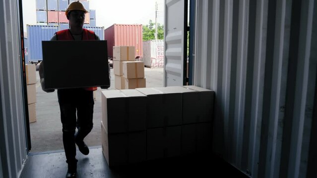 Group of strong worker help lifting and stacking together many boxes of goods  in containers at the transportation warehouse. Cargo container and Transport Logistic concept