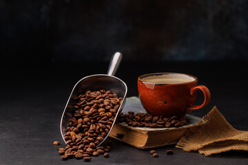 Rich coffee in a cup with aromatic roasted beans