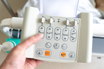 Hospital bed control box with buttons. Medical equipment, remote control panel of adjustable electric bed for a patient in a recovery room.
