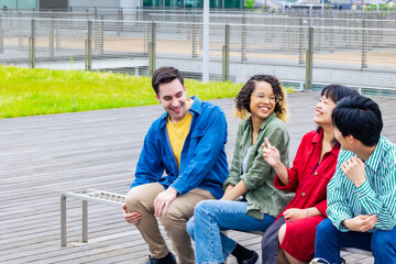 Multinational youth group talking in college campus. College students.