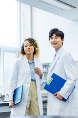 Group of multinational people wearing white robe in classroom.