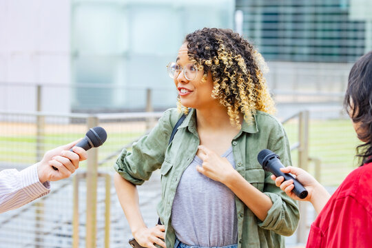 African Woman Being Interviewed On The Street By The Media.