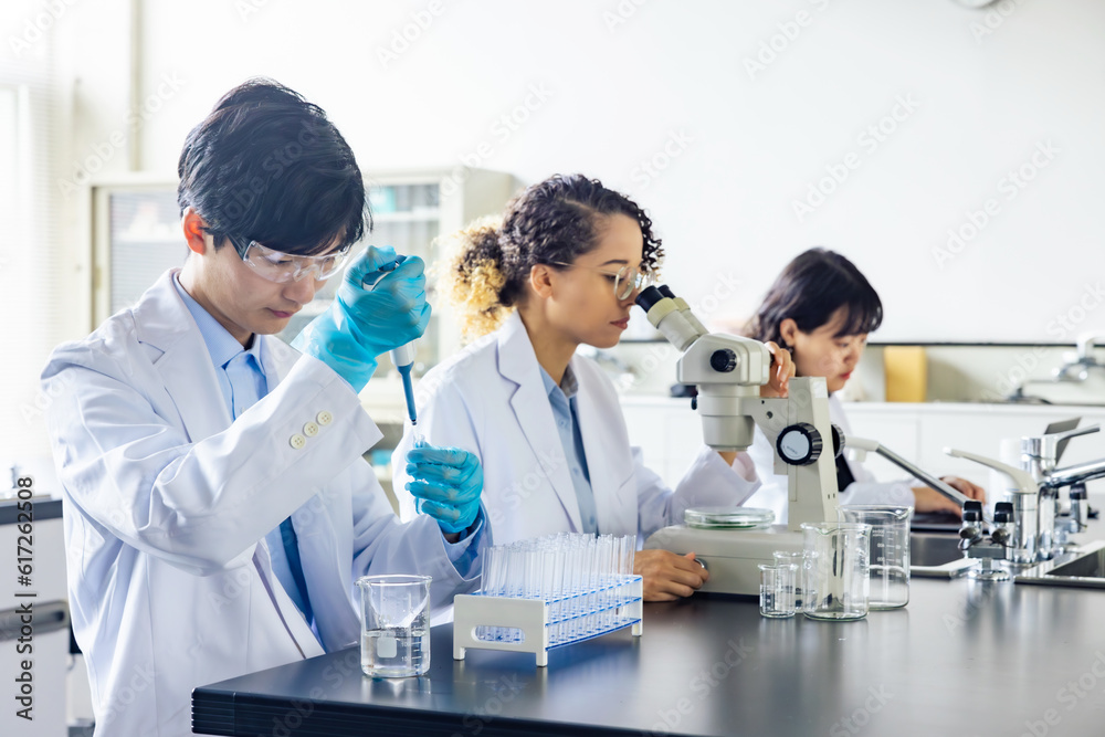 Poster multinational researcher group experimenting in the lab.