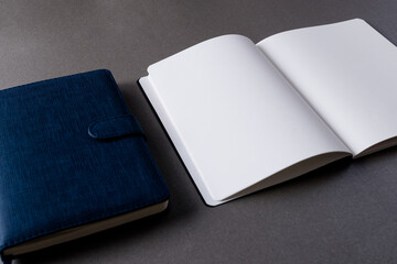 Close up of blue notebook and open book with copy space on grey background