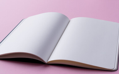 Close up of open book with copy space on pink background