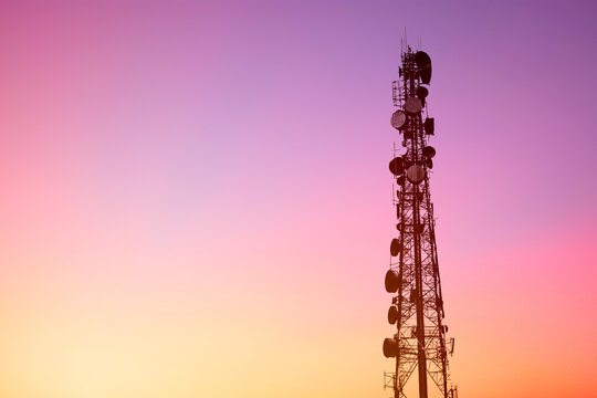 4G or 5G digital data telecommunication tower network telephone cell site with blank dusk sky copy space for text, communication internet infrastructure technology.