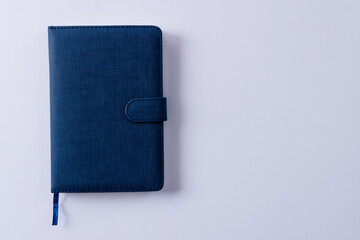 Close up of blue notebook with copy space on white background