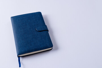 Close up of blue notebook with copy space on white background