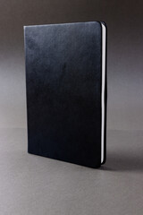 Close up of black notebook with copy space on black background