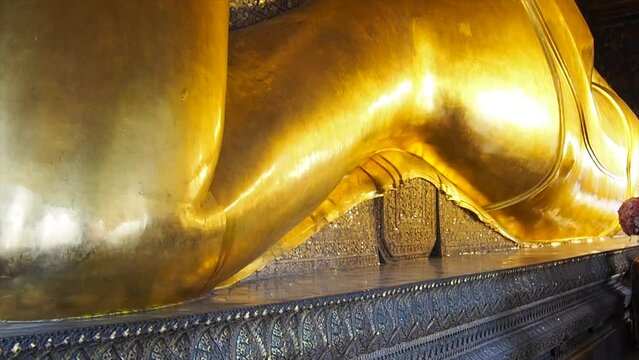 Golden, lying buddha statue in Wat Pho in Bangkok, Thailand