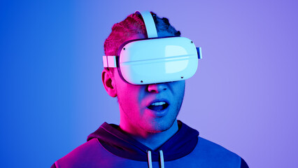 technology, online game, entertainment, virtual world in 3D simulation. millennial man in vr glasses plays in neon, studio shot, 3d render