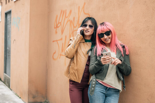 urban women on the street wall with smart phone