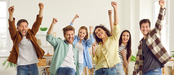 Team of happy young people celebrating and having fun together. Group of six joyful men and women friends in casual clothes celebrating success or getting excited because the weekend started. Banner