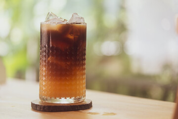 Shot of black coffee and fresh orange juice is a cup of ice coffee, ice coffee with orange juice combine tastiest flavor combination. Refreshing summer drink.