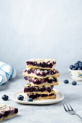 Stack of pieces of shortbread cake with blueberry filling. Homemade pastry with summer berries....